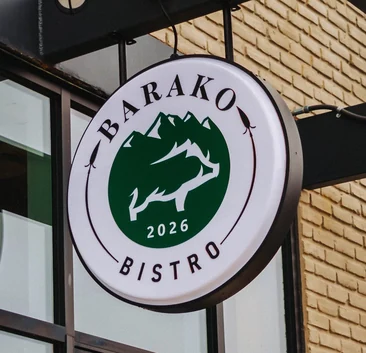 Barako Bistro round sign with the boar and mountain logo