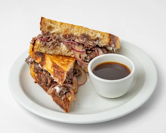 Bistek beef dip: braised beef, cheese and red onion on toasted sourdough with a cup of jus
