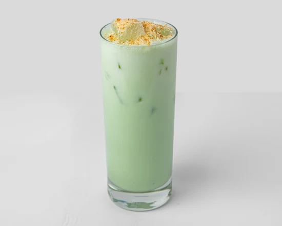 Buko pandan, a pale green pandan coconut milk drink with toppings, in a tall glass
