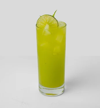 Calamansi mojito with ice, a citrus wheel and mint in a tall glass